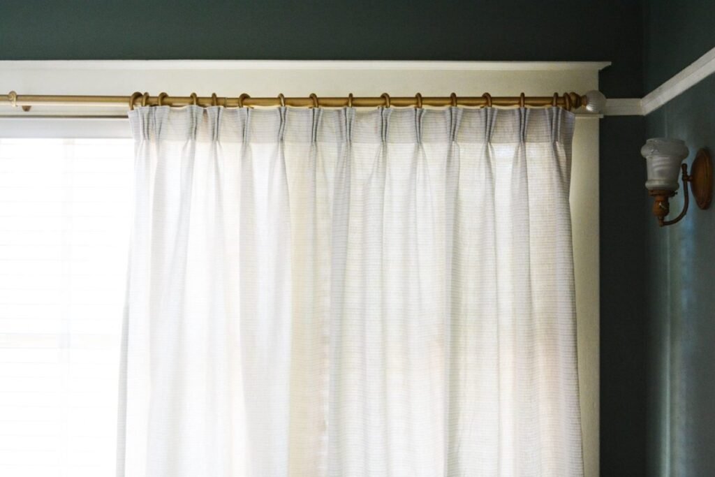 Sheer white curtains allowing soft light into the room.