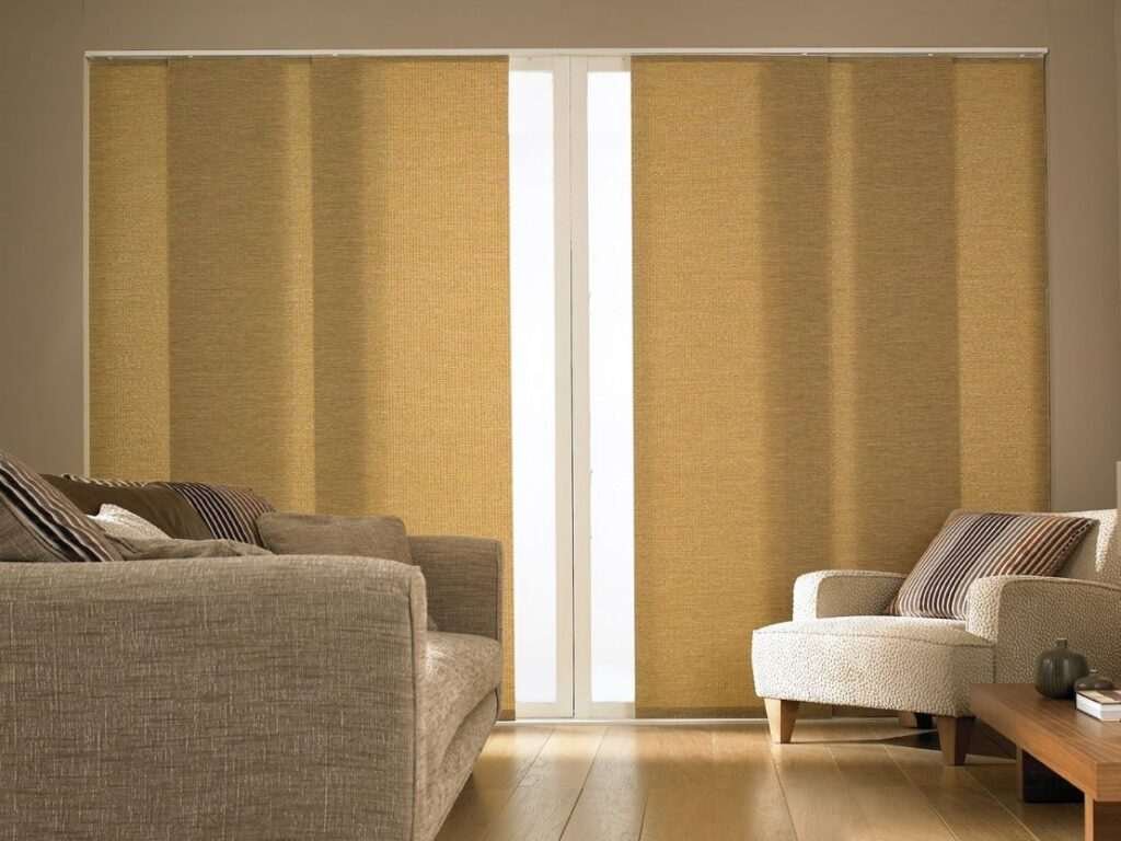 Light-filtering panel blinds installed in a Dubai apartment with panoramic windows.