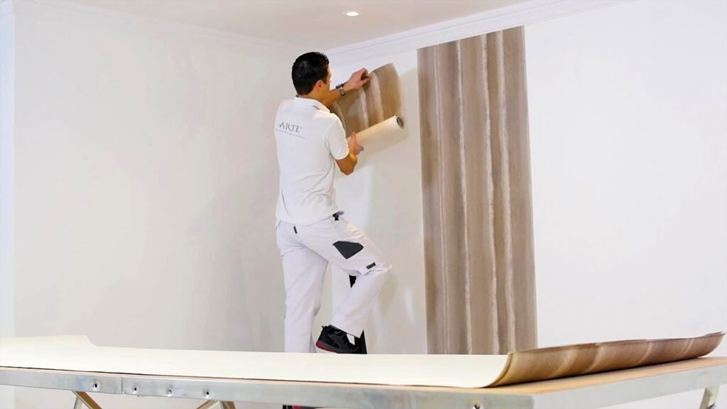 Close-up views of wallpaper fixing with glue application and wall alignment.