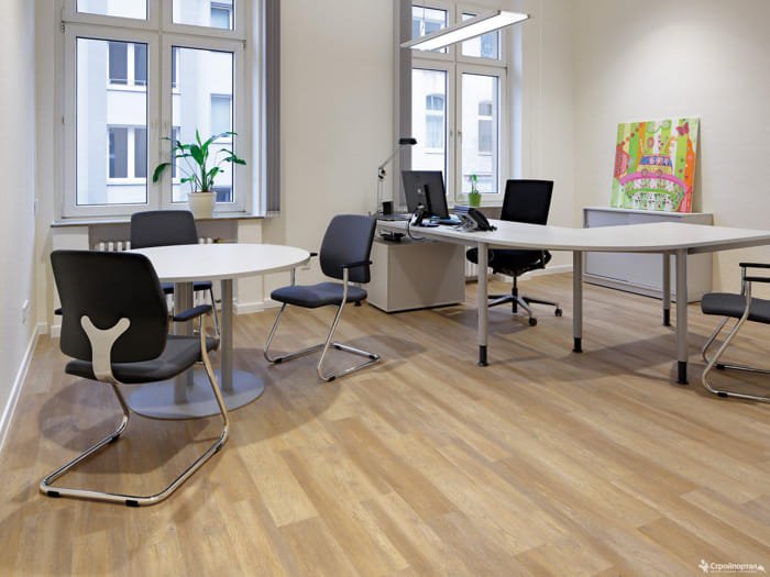 Stylish office or meeting area with warm brown wooden flooring and contemporary chairs.