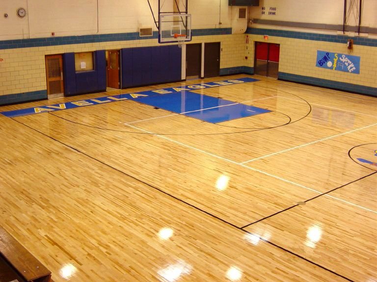 Modern workout area with gray vinyl sports flooring and fitness equipment.