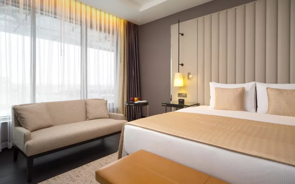 Modern twin bedroom with yellow accents and large window