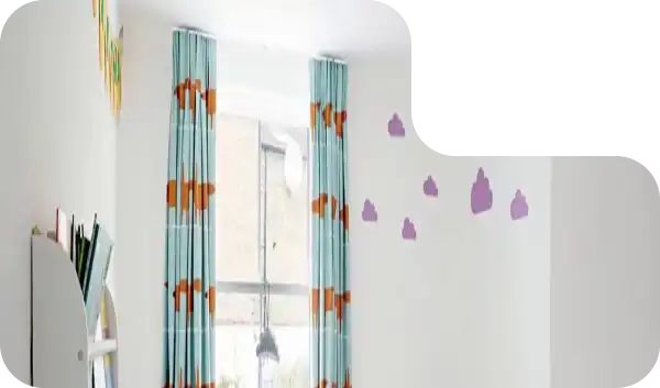 Light blue kids' curtains with orange animal patterns in a bright, minimalistic room