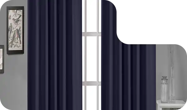 Dark navy blue blackout curtains in a modern room with grey walls and framed artwork.