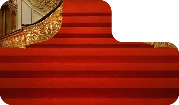 Royal red carpet staircase with ornate golden railing in a luxurious venue