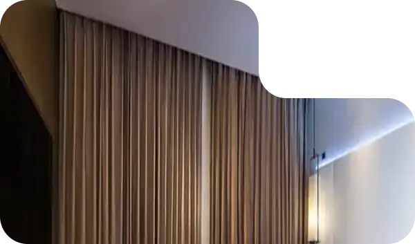 Full-height blackout curtains in a modern hotel room with wall-mounted ambient lighting