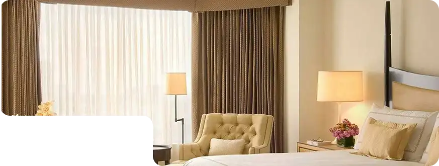 Cozy hotel room with golden-brown blackout curtains and modern decor