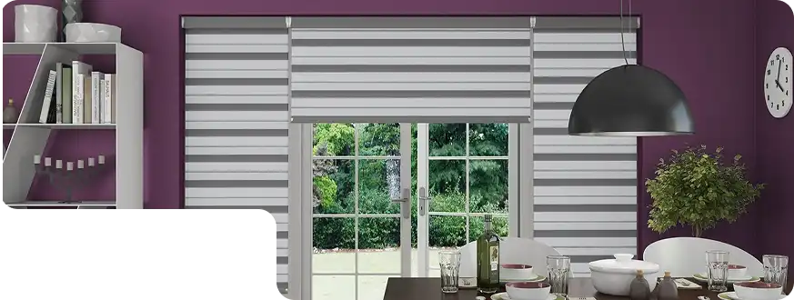 Grey duplex blinds covering large glass doors in a stylish dining room with purple walls