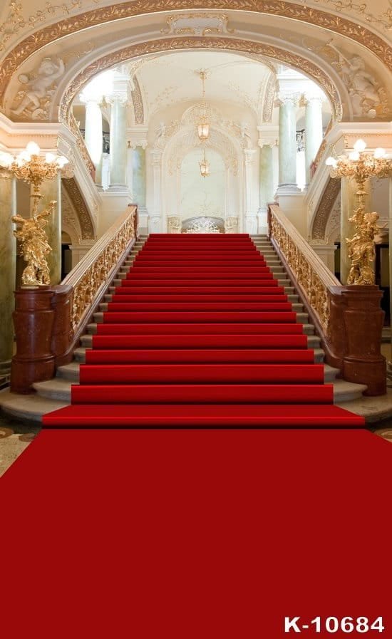 Elegant staircase with red carpet in a luxurious hall