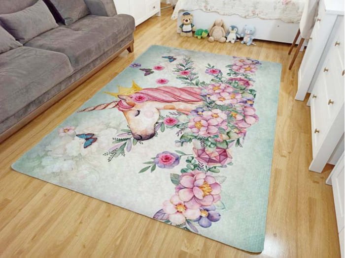 Kids play mat with pink floral patterns and cartoon animals on a light background.