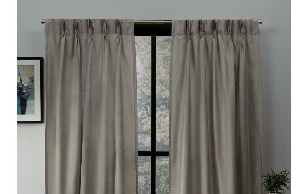 Gray textured curtains hanging in a modern window frame.