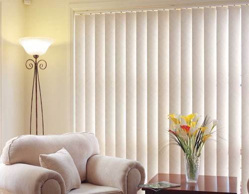 Soft-colored vertical blinds creating a cozy and private bedroom in Dubai.