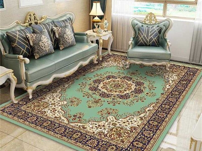 Oriental Persian rug in green with golden floral motifs styled in a contemporary living room.