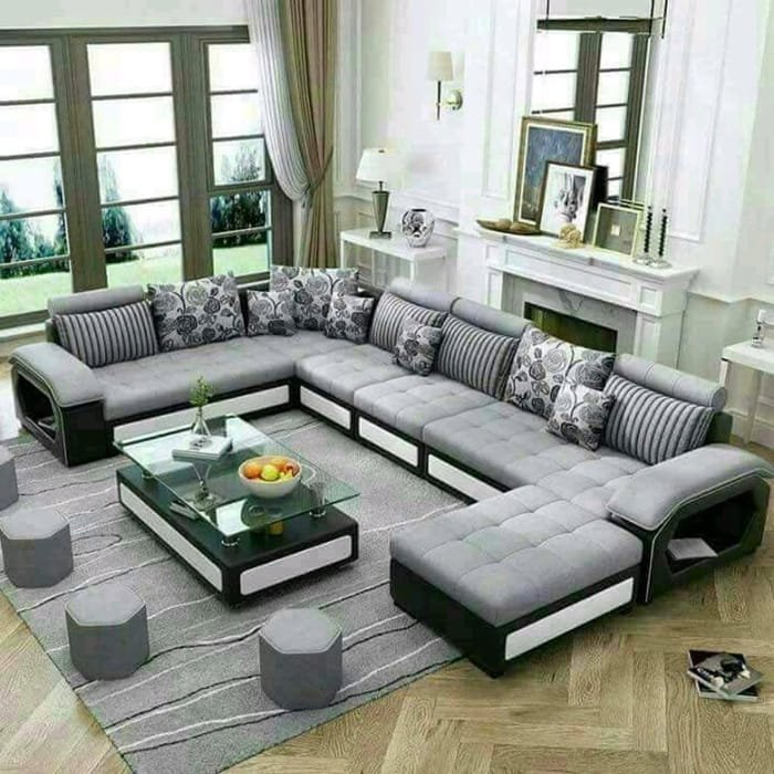 Grey U Shape sofa in a sunlit room with large windows and glass table