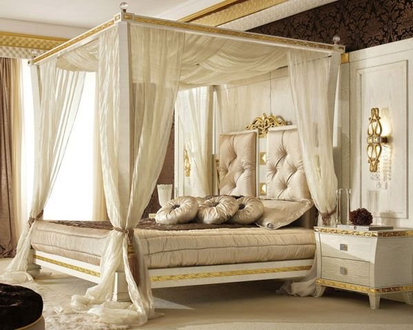 Traditional carved wooden canopy bed with royal design elements.