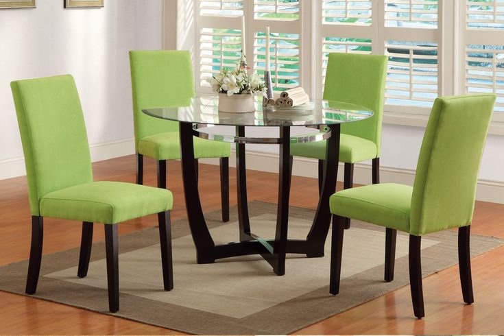 Glass-top black dining table set with light green fabric chairs