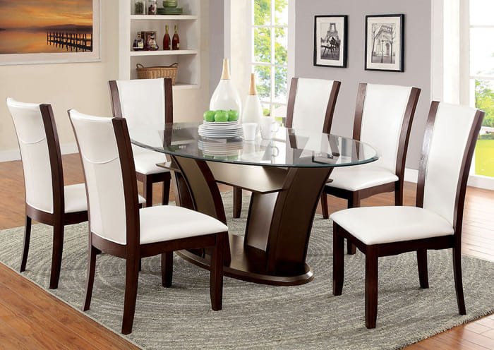 Round glass-top dining table with dark wood base and white cushioned chairs.