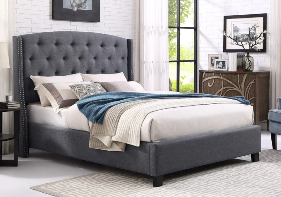 Elegant king size upholstered bed with soft fabric and storage drawers.