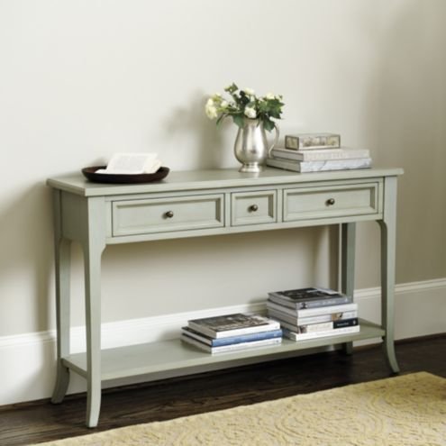 Light gray console table with two drawers and a bottom shelf, styled with decor accents.