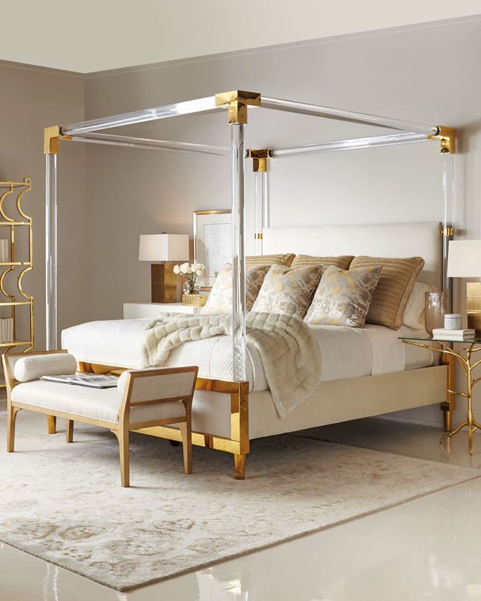 Luxury wooden canopy bed with elegant drapes in a modern bedroom.