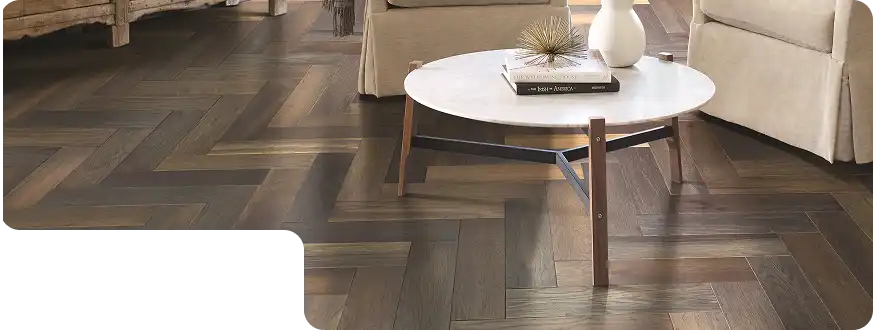 High-quality herringbone wood flooring pattern in dark brown tones, perfect for Dubai homes.