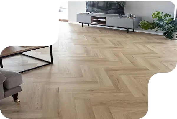 Close view of luxury herringbone parquet flooring in natural wood finish for Dubai properties.