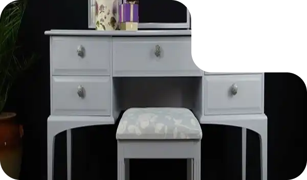 Modern glass top dressing table with gold frame and upholstered stool.