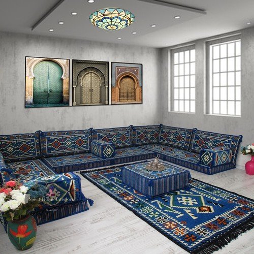 Modern majlis with blue velvet sofas and Islamic wall art