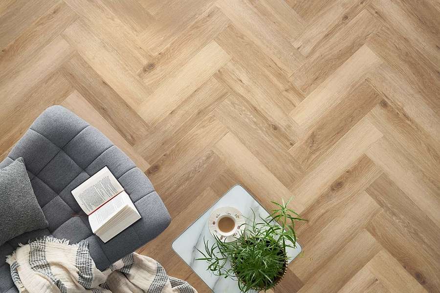 Beautiful herringbone parquet flooring in a modern Dubai bedroom with minimalist design and soft lighting.