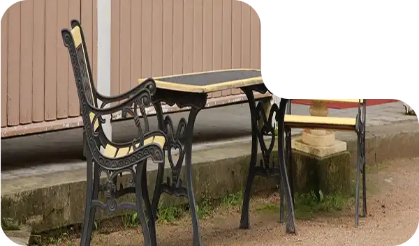 Comfortable wooden outdoor chairs with soft white cushions for lakeside seating.