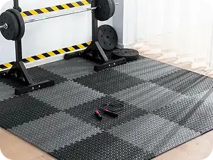 Puzzle-style interlocking gym mats partially assembled in a garage gym.