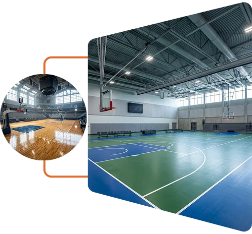 Indoor sports hall with green and blue multi-purpose court flooring and basketball hoops