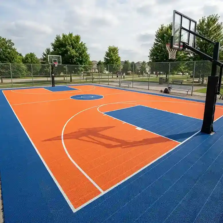 Outdoor basketball court with orange and blue modular tile flooring