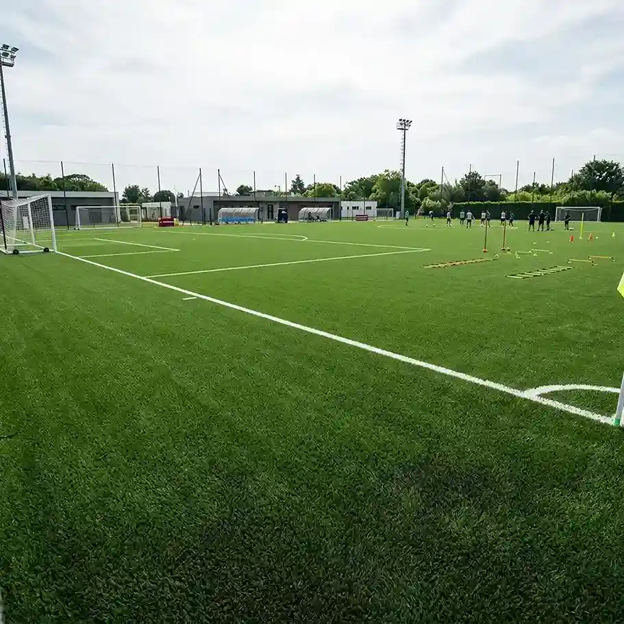 Soccer training field with green artificial turf and goalposts